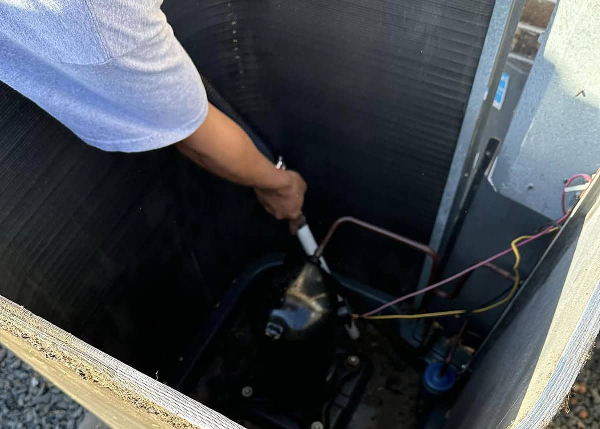 Bolton Heating & Air performing an annual tune-up at a home in the DFW