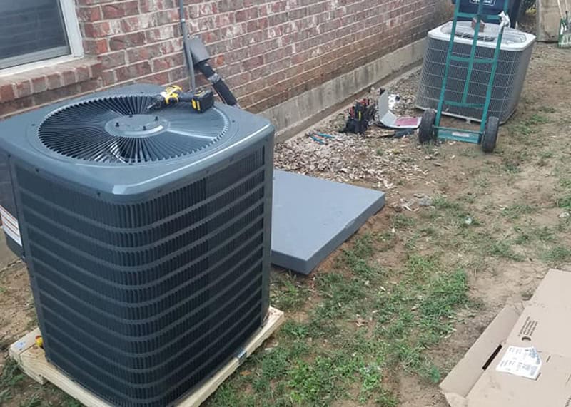 New HVAC unit installation next to an older AC system at a DFW home, illustrating the $5,000 AC repair or replace rule.