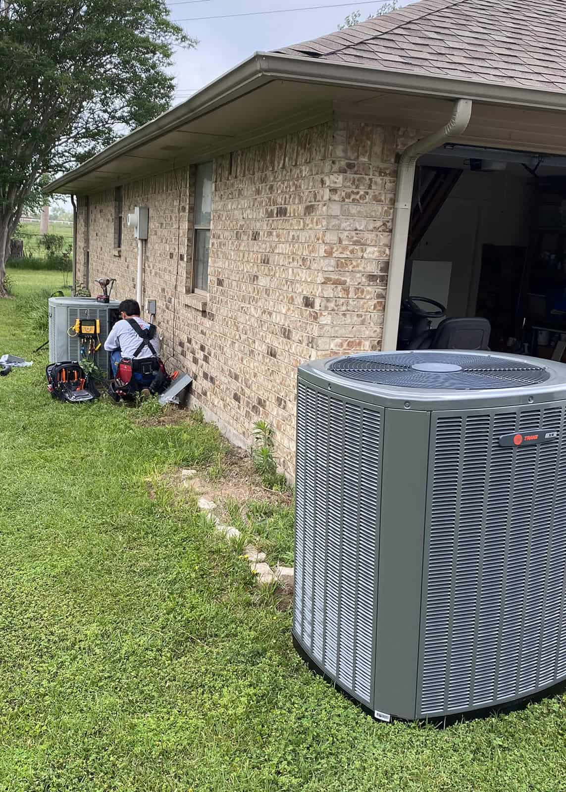 HVAC technician replacing an old air conditioning unit