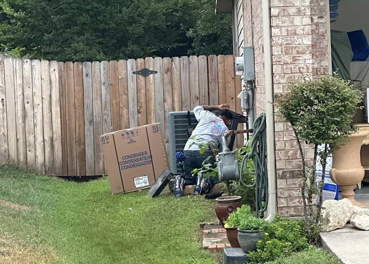 HVAC technician replacing outdoor AC condenser unit with new system at a home in Forney, TX – Bolton Heating & Air