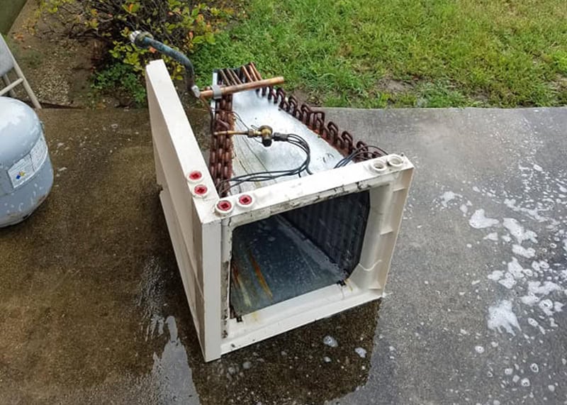 Removed HVAC evaporator coil on patio during AC repair and replacement service