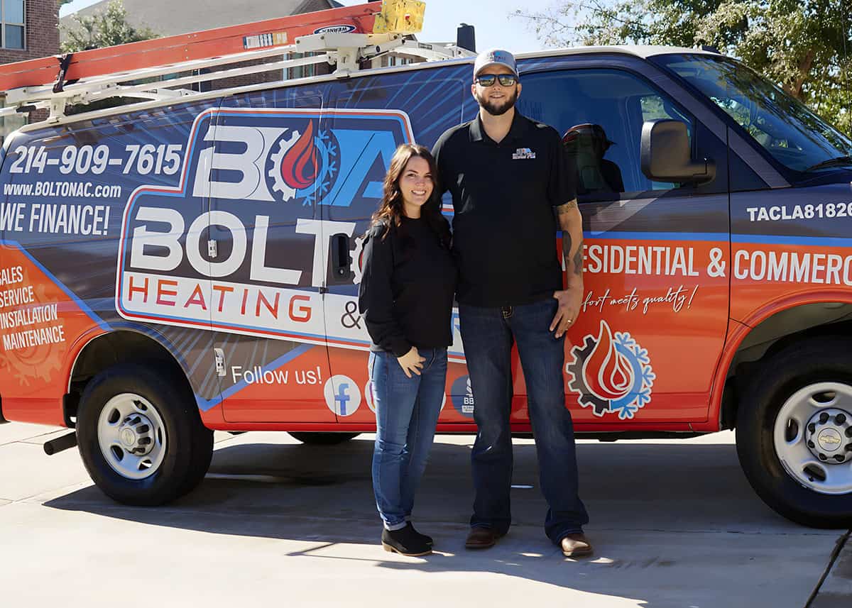 Jacob and his wife standing in front of a Bolton Heating & Air service van
