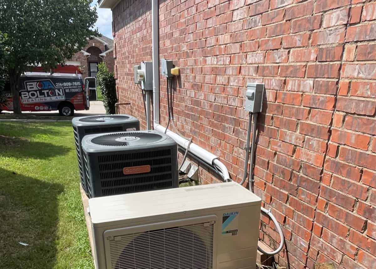 AC technician fixing a broken air conditioning unit