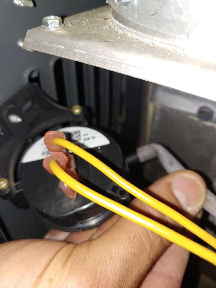 Technician testing a furnace pressure switch during HVAC repair to diagnose ignition and airflow problems in a gas heating system
