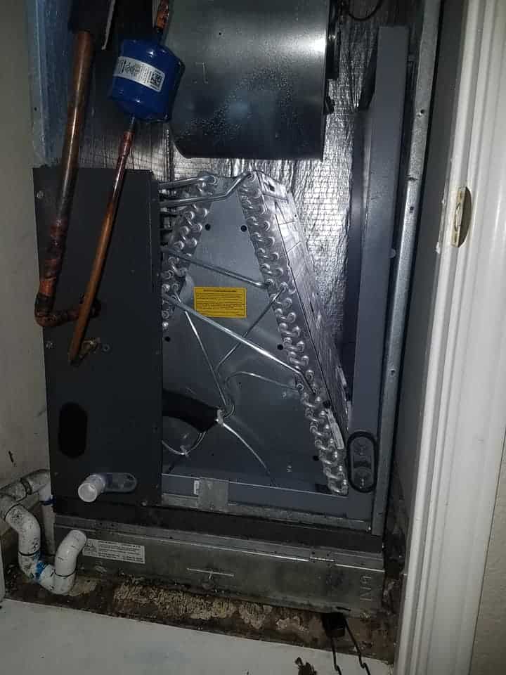 Gas furnace heat exchanger inside a residential HVAC system during inspection for cracks and carbon monoxide safety issues