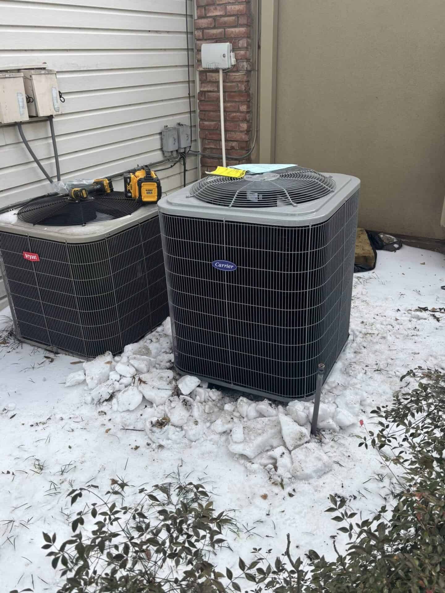 Technician replacing an outdoor heat pump system in Forney, TX during cold winter weather