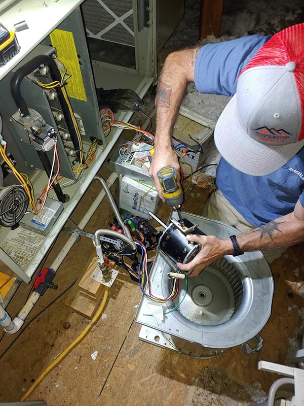 AC technician servicing an HVAC unit at a home in Forney